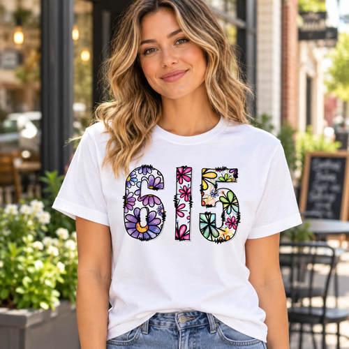 Woman wearing white 615 floral Nashville graphic tee