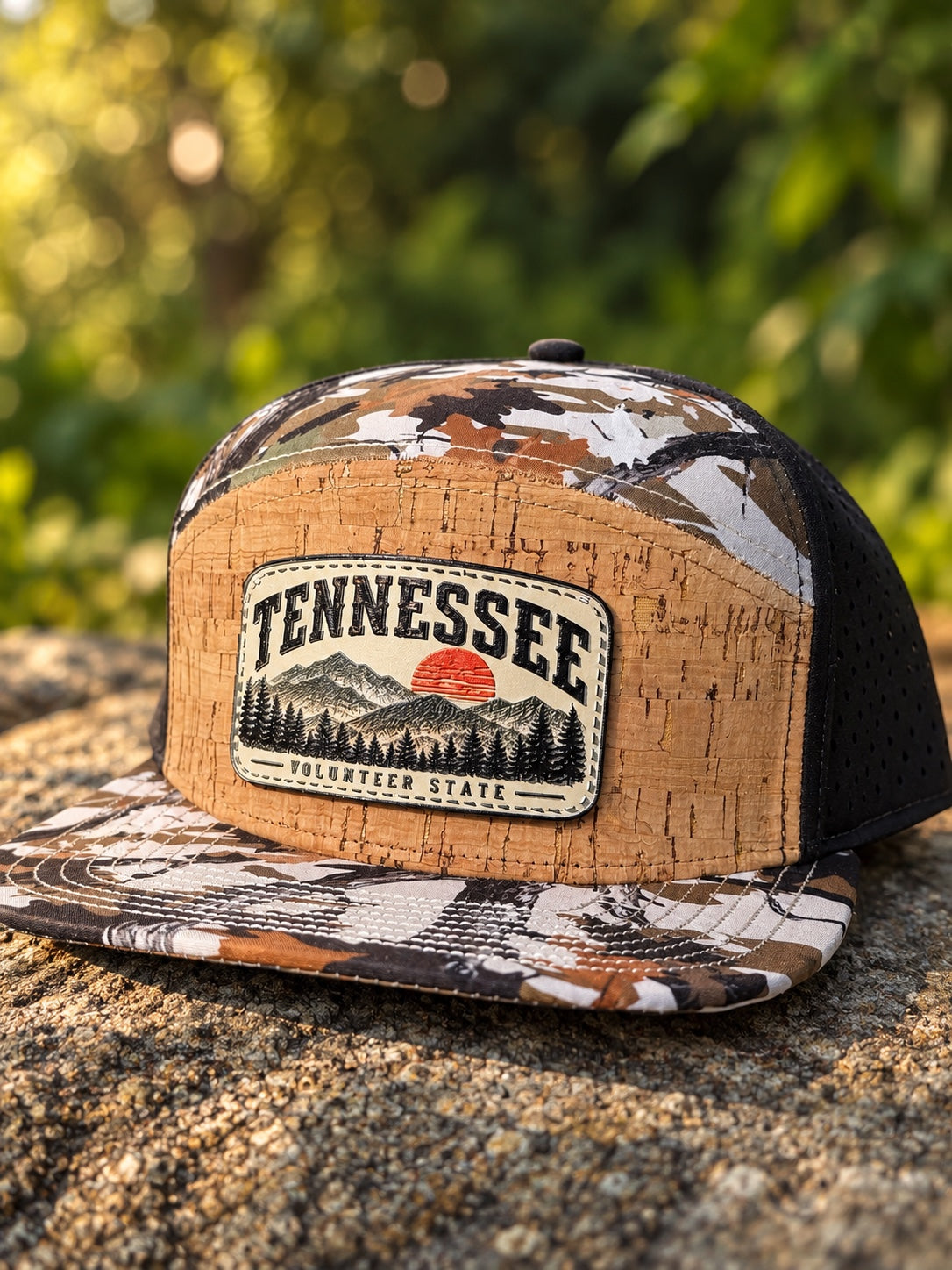 Tennessee Volunteer State mountain sunset patch on a camouflage hat with cork-look front and black sides