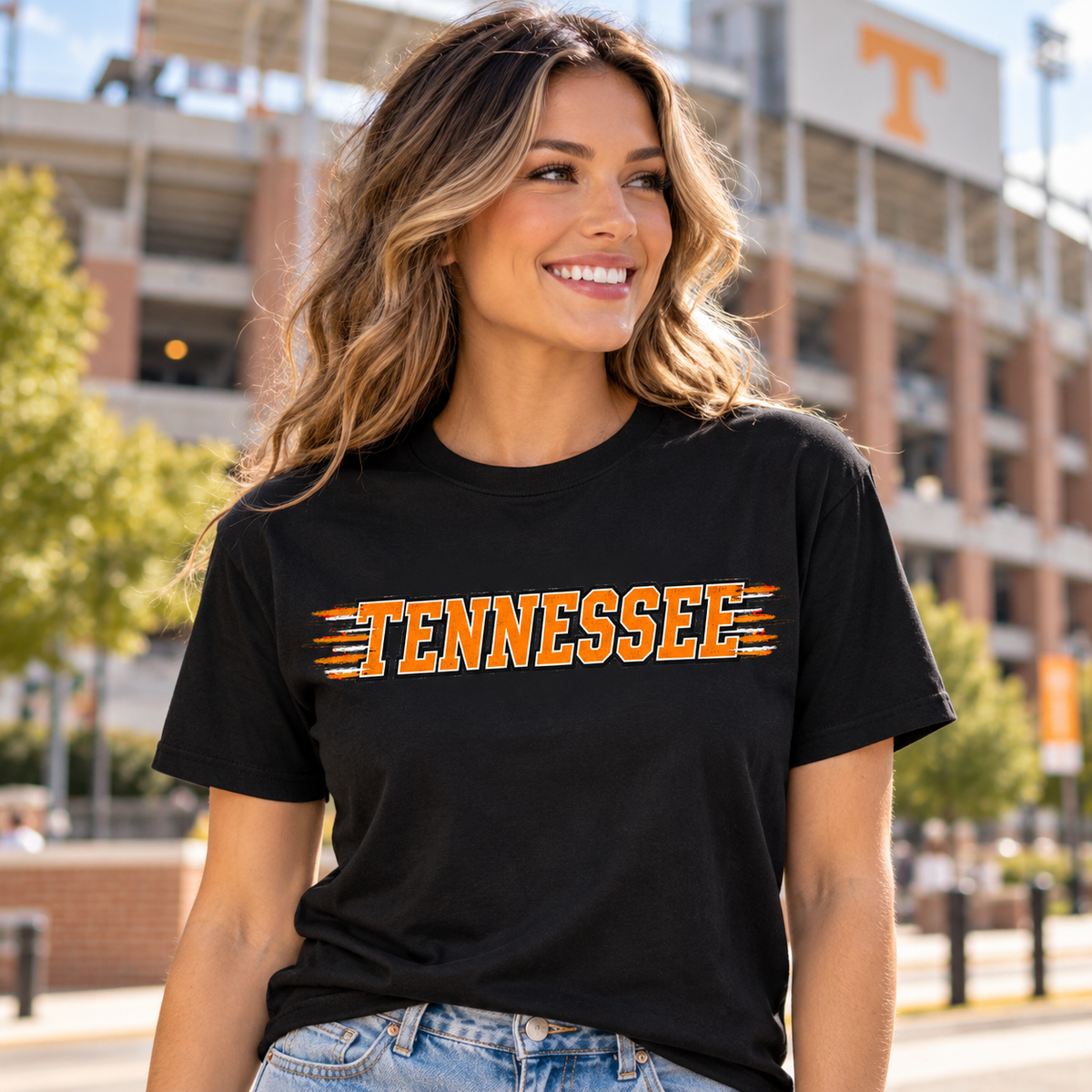Woman wearing black Tennessee orange speed lines graphic tee