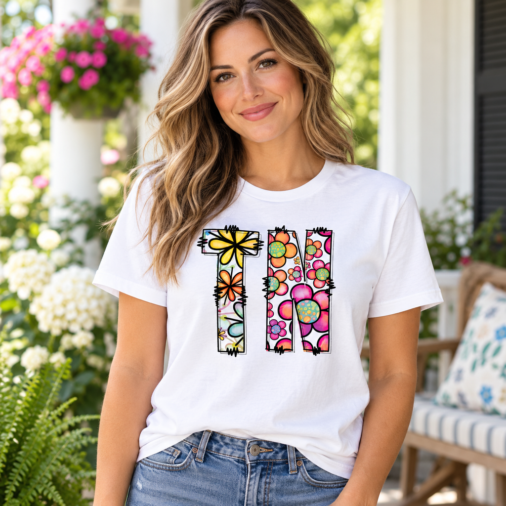 Woman wearing white TN floral Tennessee graphic tee