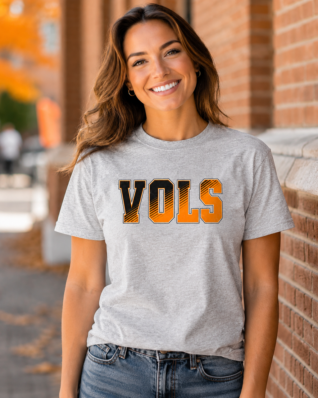 Woman wearing ash gray VOLS orange and black diagonal graphic tee