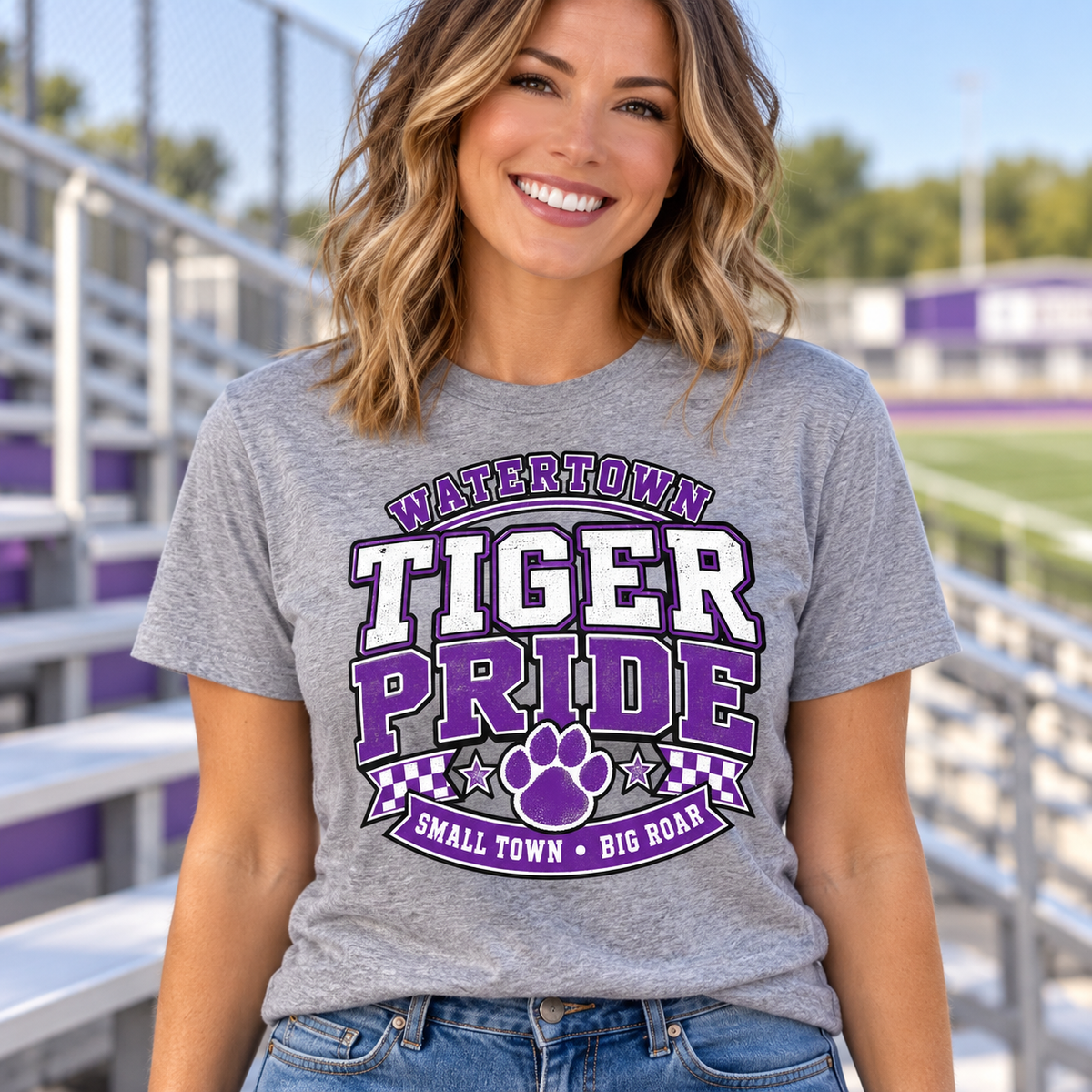 Woman wearing a heather gray Watertown Tiger Pride Small Town Big Roar graphic tee